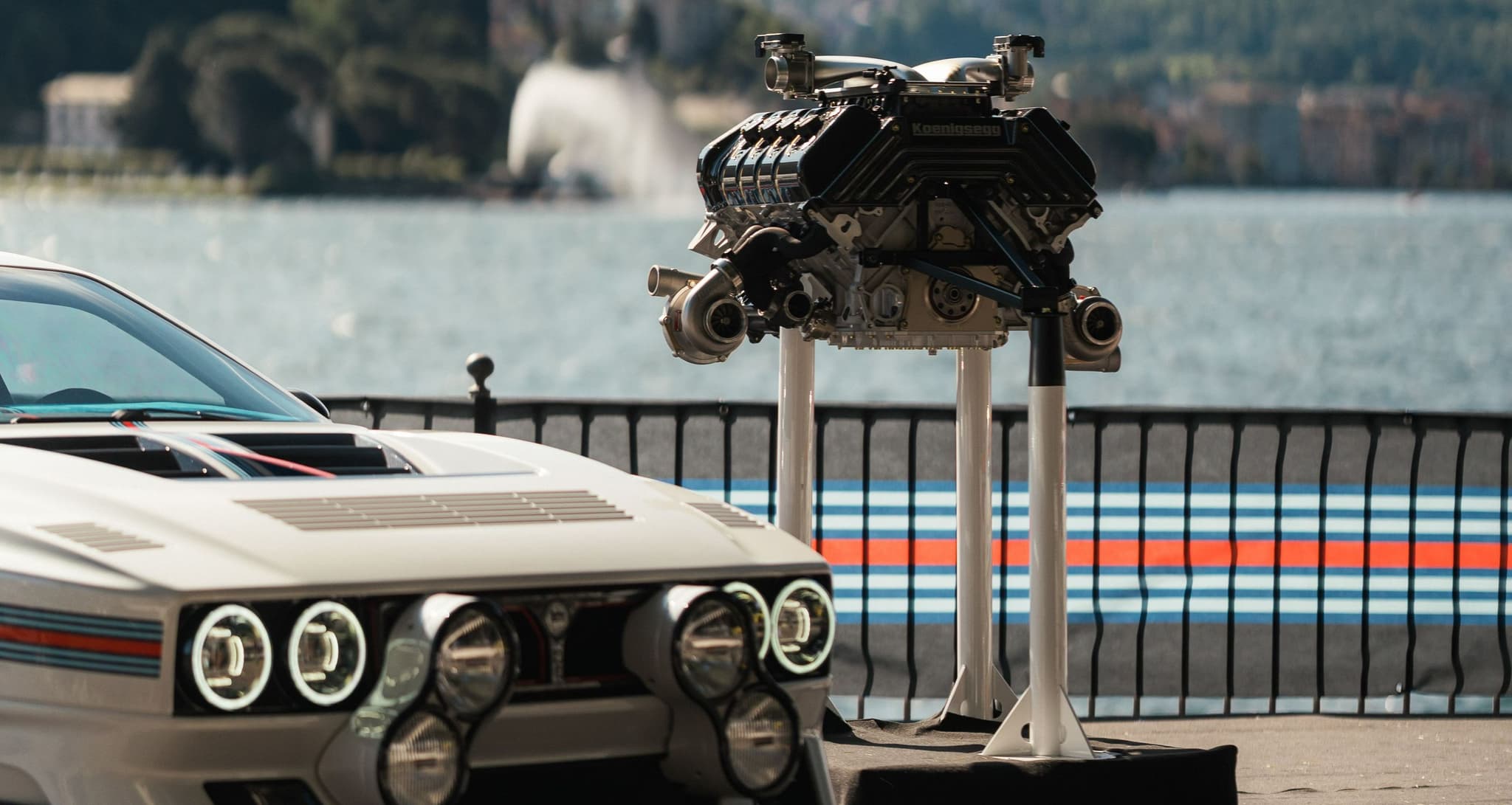 Kimera Automobili com decoração Martini e o motor em exposição junto a um lago